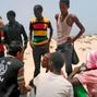 Illegal migrants landed on the beach in front of amazed tourists